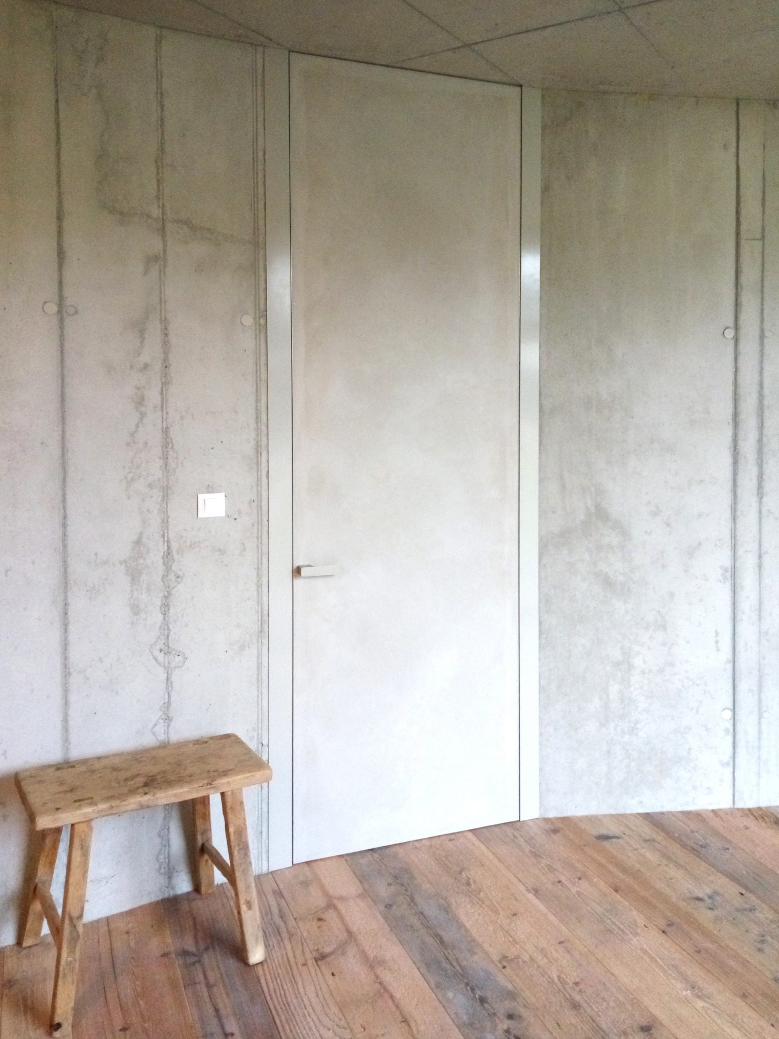 hidden door frame in a monolithic wall with stainless steel cover • doors and hidden door frames