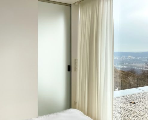 All-glass Belport sliding door in a cladding construction case