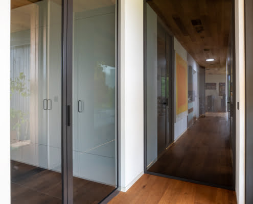 AXON pivot door and DIGERO sliding all-glass wall